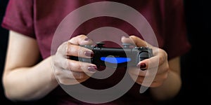 Ukraine, Odessa - July 2, 2019: A girl plays a video game on a playstation 4 joystick. The ps4 gamepad is in the girlÃ¢â¬â¢s hands.