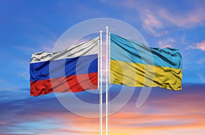 Ukraine and Russia two flags on flagpoles and blue sky