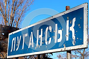 Ukraine Russia war Road sign in Ukrainian - Lugansk, pierced by bullets, Ukrainian war in Donbass destruction, Ukraine border, ATO photo