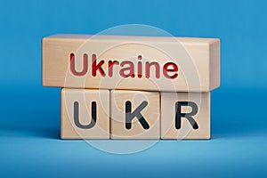 Ukraine and UKR symbol. Concept words Ukraine and UKR on wooden blocks.