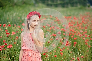 Ukrainian Beautiful girl in field of poppies and wheat. outdoor portrait in poppies
