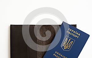 Ukrainian biometric passport id on a leather passport cover to travel the Europe without visas on the table. Inscription