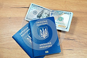 Ukrainian biometric passport id to travel the Europe with dollars money on the table. Inscription in Ukrainian