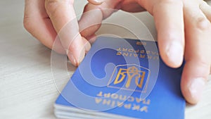 Ukrainian biometric passport for traveling in Europe without visas on the table. Inscription in Ukrainian Passport of