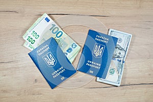 Ukrainian biometric passports id to travel the Europe with dollars and euros money on the table. Inscription in Ukrainian