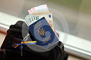 Ukrainian biometrical passport and Euro money with Airlines avia tickets on touristic backpack