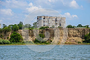 Ukrainian block of flats on the Danube river shore seen from romanian side - Danube river Ukraina - steep ground wall - Ucraina