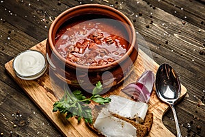 Ukrainian borsch soup and garlic buns on the table.