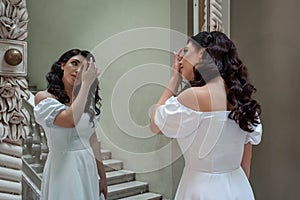 Ukrainian bride preens at the mirror.