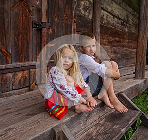 Ukrainian children near old wooden house photo