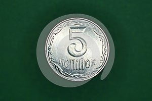 Ukrainian coin five kopecks  on a green background photo