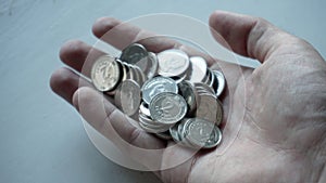 Ukrainian coins with a face value of two hryvnias in a man's hand