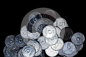 Ukrainian coins isolated on black background. Close-up view. Coins are located below the center of frame.