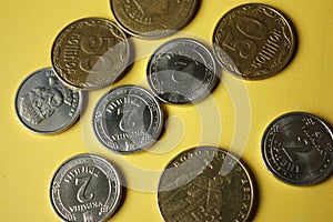 Ukrainian coins isolated on yellow background. Close-up Coins are located in the center of the frame. Conceptual image