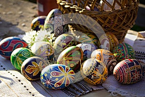 Ukrainian Easter eggs `pysanky` beside a basket photo