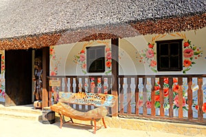 Ukrainian ethnic house museum with national paintings and sculptures. A small village hut under thatched roof. Park New Sofievka,