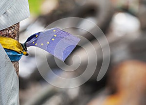 Ukrainian EUROMAIDAN 2014. Ukrainian and EU Strips linked together with barricade tyres on the background photo