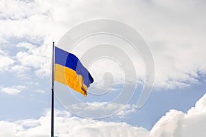 Ukrainian flag blowing on a wind bright sky background simple wallpaper advertising copy space concept