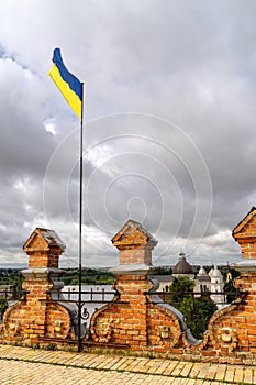 Ukrainian flag on castle tower in sky background