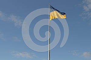 Ukrainian Flag Soaring in a Clear Blue Sky