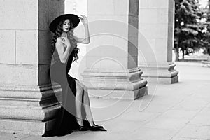 Ukrainian girl in a black dress outdoors in a hat