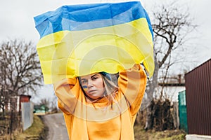 Ukrainian girl holding ukrainian flag