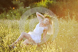 Ukrainian girl in a white sundress with a wreath of flowers on h