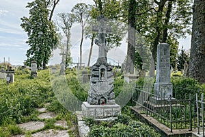 Ukrainian gravestone on old abandoned Polish city cemetery in Zhydachiv, Lviv region, Ukraine. Weathered stone tombstone