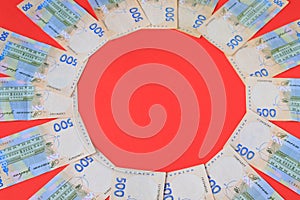 Ukrainian hryvna, banknotes 500 hryvnia, on red background, money concept, Christmas, New Year gifts, shopping. Ukraine gryvna