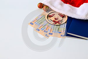 Ukrainian hryvna, banknotes 500 hryvnia, with toy pig 2019, red Santa Claus hat and blue passport on white background, isolate.