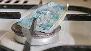 Ukrainian hryvnia on a gas water heater without fire. Gas stove with money. Conceptual image of a rising tariff for violence.