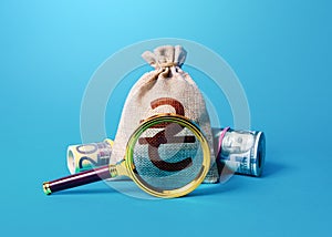 Ukrainian hryvnia money bag and magnifying glass. Anti money laundering, tax evasion. Deposit or loan terms and conditions. Find