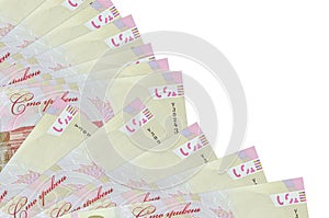 100 Ukrainian hryvnias bills lies isolated on white background with copy space stacked in fan close up