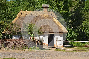 Ukrainian hut with a wicker wooden fence
