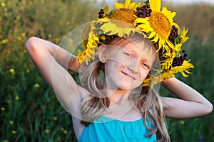 Ukrainian kid girl at the field of sunflowers