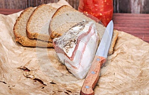 Ukrainian lard with black bread and spicy sauce of tomatoes and