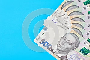 Ukrainian money on blue background. Payment of pensions, salaries