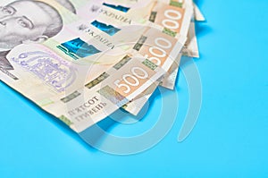 Ukrainian money on blue background. Payment of pensions, salaries