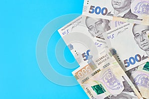 Ukrainian money on blue background. Payment of pensions, salaries