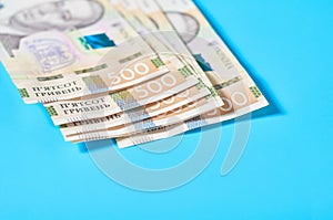 Ukrainian money on blue background. Payment of pensions, salaries