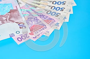 Ukrainian money on blue background. Payment of pensions, salaries