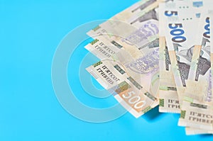 Ukrainian money on blue background. Payment of pensions, salaries