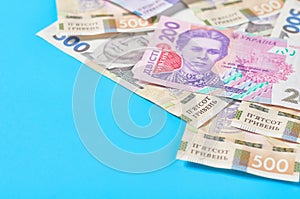 Ukrainian money on blue background. Payment of pensions, salaries