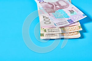 Ukrainian money on blue background. Payment of pensions, salaries