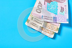 Ukrainian money on blue background. Payment of pensions, salaries