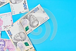 Ukrainian money on blue background. Payment of pensions, salaries