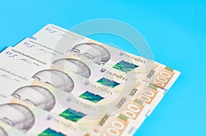 Ukrainian money on blue background. Payment of pensions, salaries