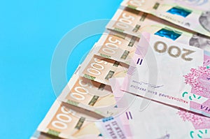 Ukrainian money on blue background. Payment of pensions, salaries