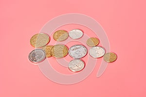 Ukrainian money, coins on pink background. Payment of pensions, salaries