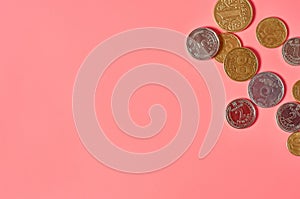 Ukrainian money, coins on pink background. Payment of pensions, salaries
